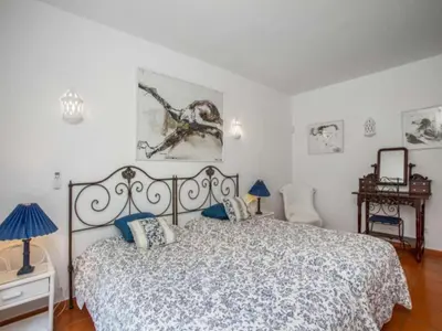a bedroom with a large bed with blue pillows at Beautiful Algarve Villa 5 Bedrooms Villa Pilar Amazing Beach & Sea Views in Albufeira