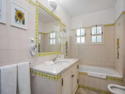 a bathroom with a sink and a tub and a mirror at Beautiful Algarve Villa 5 Bedrooms Villa Pilar Amazing Beach & Sea Views in Albufeira