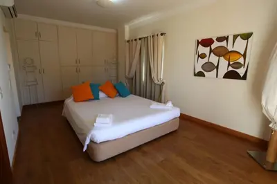 a bedroom with a bed with orange and blue pillows at Amazing Portuguese Villa Villa Heroine 6 Bedrooms Stunning Position in Albufeira