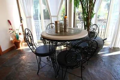a table and chairs in a room with windows at Amazing Portuguese Villa Villa Heroine 6 Bedrooms Stunning Position in Albufeira