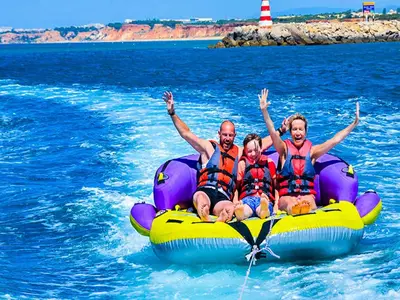 a group of people sitting on a raft in the water at Luxury Penthouse Apartment Private Jacuzzi, Albufeira in Albufeira