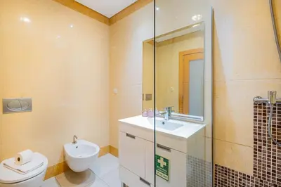 a bathroom with a toilet and a sink and a shower at Apartment Oura - Views of sea, Albufeira bay & Old Town in Albufeira