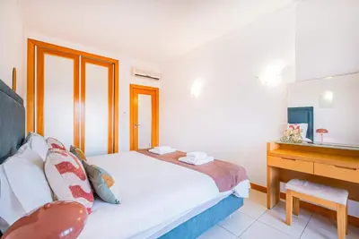 a bedroom with a bed and a desk at Apartment Oura - Views of sea, Albufeira bay & Old Town in Albufeira