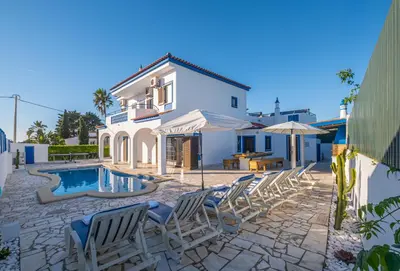 a villa with a swimming pool and lounge chairs at Villa Amaris by Atlantic Places in Albufeira