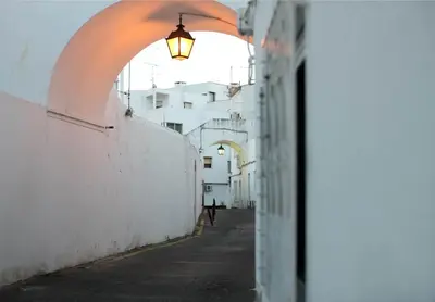 an alley with an archway and a light on a wall at Apartment Aiko - Downtown Albufeira in Albufeira