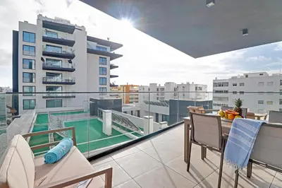 a balcony with a view of a building at Sky Beach Apartment in Quarteira