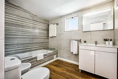 a bathroom with a toilet and a tub and a sink at Villa Mitto in Albufeira