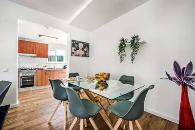 a kitchen and dining room with a glass table and chairs at Villa Mitto in Albufeira