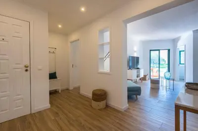 a living room with a door open to a living room at Salgados 1 Bedroom Apartment - 500m from the Beach in Guia
