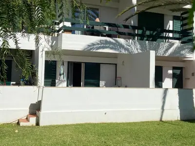 a large white house with a white wall at Casa Garcia in Quarteira