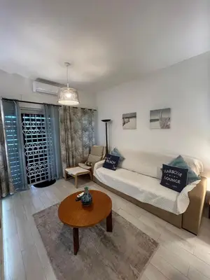 a living room with a couch and a table at Casa Garcia in Quarteira