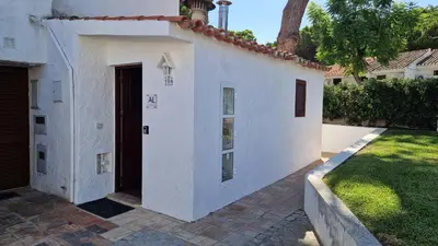 a white building with a door and a yard at Paulo's 104 in Albufeira