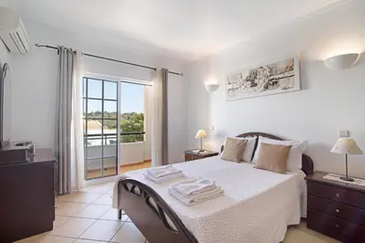 a bedroom with a bed with towels on it at Villa Catarina in Albufeira