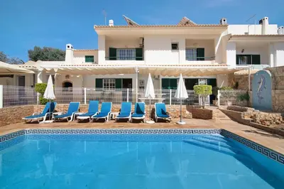 a view of the pool from the balcony of a house at Villa Guisado in Albufeira