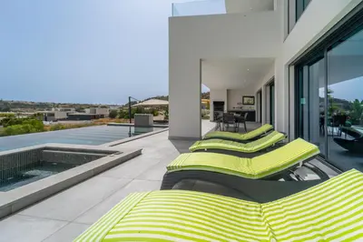 two beds on the balcony of a house at Villa das Amendoeiras by HelloVacations in Albufeira