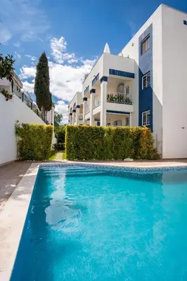 a swimming pool in front of a building at Apartment Claro Azul in Albufeira