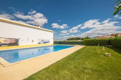 a swimming pool in the yard of a house at Apartment Alfarmar - pool, beach only a few minutes away in Albufeira