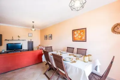 a dining room with a white table and chairs at Apartment Alfarmar - pool, beach only a few minutes away in Albufeira