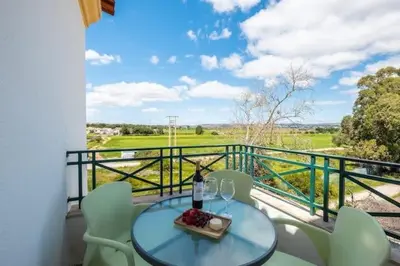 a table and chairs on a balcony with a view at Apartment Alfarmar - pool, beach only a few minutes away in Albufeira