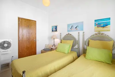two beds sitting next to each other in a bedroom at T3 Duplex Albufeira in Olhos de Água