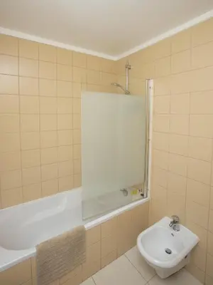 a bathroom with a tub and a toilet and a sink at Holiday Albufeira in Albufeira