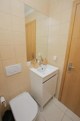 a bathroom with a white toilet and a sink at Holiday Albufeira in Albufeira
