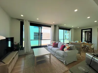 a living room with a couch and a table at Faro Design 5 by Homing in Faro
