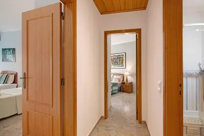 a hallway with a door leading into a room at Columbus Beach Apartment in Quarteira