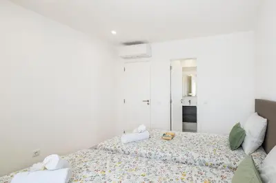 a white room with two beds and a mirror at Apartment Brisbane by Algarve Vacation in Albufeira
