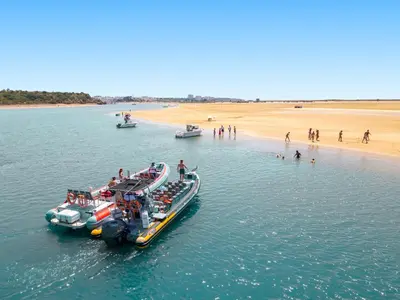 two boats in the water next to a beach at Apartment Montego Bay by Algarve Vacation in Albufeira
