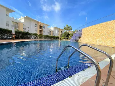 a swimming pool with a metal hand rail next to a building at SeaViewSunset - Encosta da Orada in Albufeira