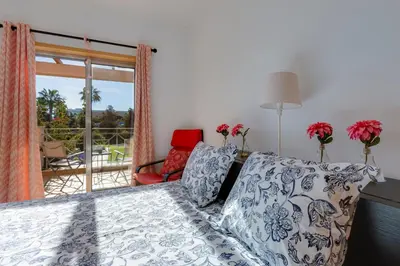 a living room with a couch and a window at BALAIA RESIDENCE - Fantástica moradia para 6 com piscina e BBQ in Olhos de Água