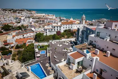 an aerial view of a city with buildings and the ocean at Coração do Mar by OCvillas in Albufeira