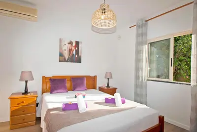 a bedroom with two beds with purple pillows at Villa Hollywood by Algarve Vacation in Albufeira