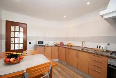 a kitchen with a table with a bowl of fruit on it at Villa Hollywood by Algarve Vacation in Albufeira