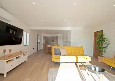 a living room with a yellow couch and a table at Villa Hollywood by Algarve Vacation in Albufeira
