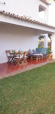 a patio with two chairs and a table and chairs at Estúdio na Falésia in Albufeira