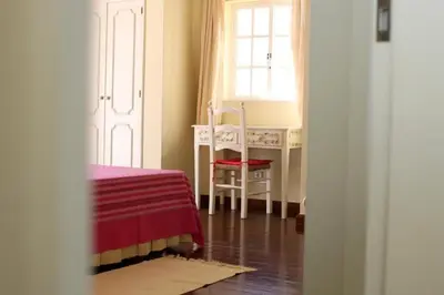 a room with a bed and a desk and a window at Villa Juniper fenced pool spacious house in Albufeira