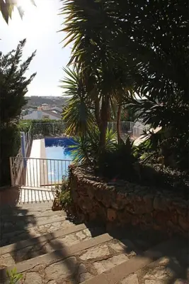 a pool with a palm tree next to a fence at Villa Juniper fenced pool spacious house in Albufeira