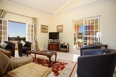 a living room with a couch and a table at Villa Juniper fenced pool spacious house in Albufeira