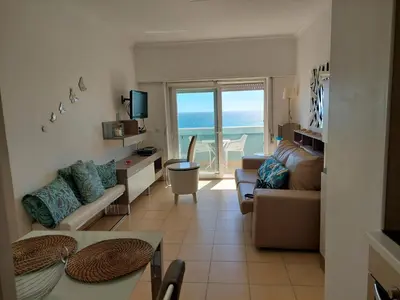 a living room with a view of the ocean at Appartement vista Mar Quarteira in Quarteira