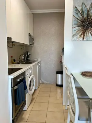 a kitchen with a washer and a sink and a washing machine at Appartement vista Mar Quarteira in Quarteira