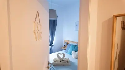 a room with a bed and a room with a door at BENAMAR HOUSE in Quarteira