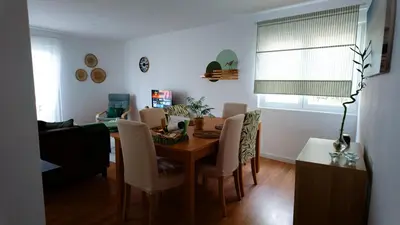 a living room with a dining room table and chairs at BENAMAR HOUSE in Quarteira