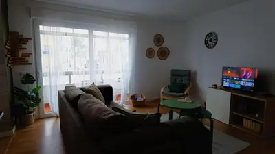 a living room with a couch and a television at BENAMAR HOUSE in Quarteira