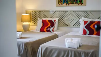 two beds in a hotel room with a lamp and two pillows at Apartamento Luna - Golf View By Dalma Portuguesa in Albufeira