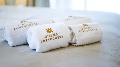 four white towels with the words dka portuguese at Apartamento Luna - Golf View By Dalma Portuguesa in Albufeira