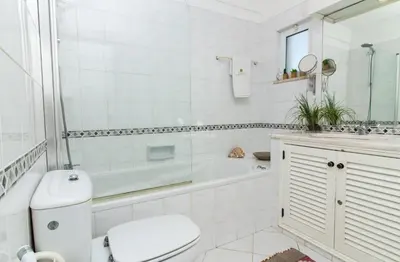 a white bathroom with a tub and a toilet and a sink at Apartamento Luna - Golf View By Dalma Portuguesa in Albufeira