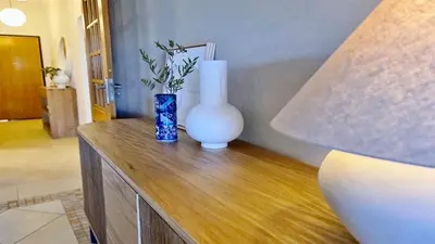 a blue and white vase sitting on a wooden table at Adam's Place (Garça Real)CD242 - Clever Details, Sleeps 4 people, Wifi, Garage in Vilamoura