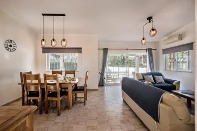 a living room with a couch and a dining room at Celina by Algarve Villa Holidays in Guia